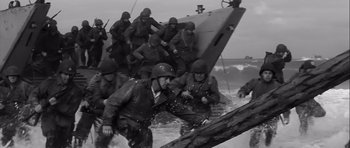 Movie still from “The Longest Day” (1962), directed by Ken Annakin – A black and white photo of a group of men on a boat; Wide shot, High angle