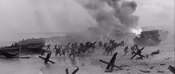 Movie still from “The Longest Day” (1962), directed by Ken Annakin – A black and white photo of soldiers running through the water; Extreme Wide shot, High angle