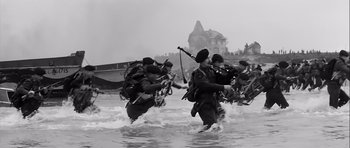 Movie still from “The Longest Day” (1962), directed by Ken Annakin – A black and white photo of a group of soldiers in the water; Wide shot, Low angle