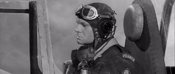 Movie still from “The Longest Day” (1962), directed by Ken Annakin – A man wearing a helmet and goggles is looking to the side; Close Up shot, Low angle