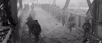 Movie still from “The Longest Day” (1962), directed by Ken Annakin – A group of men walking across a bridge; Extreme Wide shot, High angle
