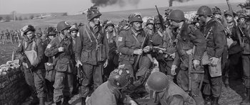 Movie still from “The Longest Day” (1962), directed by Ken Annakin – A group of men in uniforms are gathered together; Medium shot, High angle