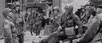 Movie still from “The Longest Day” (1962), directed by Ken Annakin – A black and white photo of a group of soldiers; Medium shot, High angle