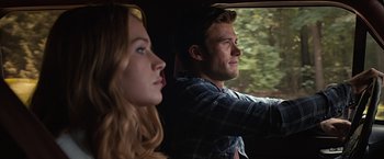 Movie still from “The Longest Ride” (2015), directed by George Tillman Jr. – A man and a woman sitting next to each other in a car; Close Up shot, Over the shoulder angle