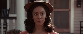 Movie still from “The Longest Ride” (2015), directed by George Tillman Jr. – A woman wearing a straw hat and a pink dress; Close Up shot, Over the shoulder angle
