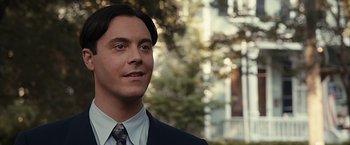 Movie still from “The Longest Ride” (2015), directed by George Tillman Jr. – A man in a suit and tie; Close Up shot, Over the shoulder angle