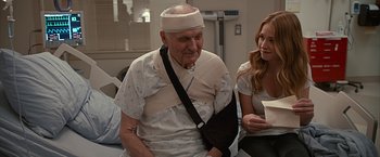 Movie still from “The Longest Ride” (2015), directed by George Tillman Jr. – An older man with a bandage on his arm; Medium shot, Over the shoulder angle