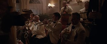 Movie still from “The Longest Ride” (2015), directed by George Tillman Jr. – A group of men in tuxedos playing musical instruments; Wide shot, Low angle