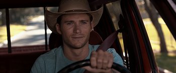Movie still from “The Longest Ride” (2015), directed by George Tillman Jr. – A man wearing a cowboy hat driving a car; Close Up shot, Over the shoulder angle