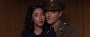 Movie still from “The Longest Ride” (2015), directed by George Tillman Jr. – A man and a woman dressed in military uniforms; Close Up shot, Overhead angle