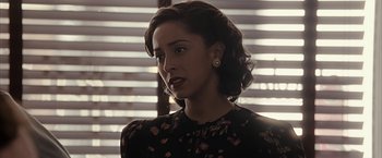 Movie still from “The Longest Ride” (2015), directed by George Tillman Jr. – A woman in a black floral dress looking to her left; Close Up shot, Over the shoulder angle