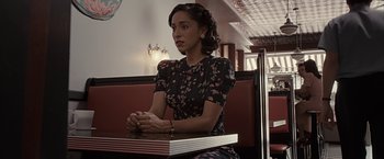 Movie still from “The Longest Ride” (2015), directed by George Tillman Jr. – A woman sitting at a table in front of a window; Medium shot, High angle