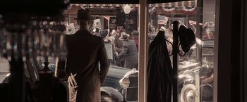Movie still from “The Longest Ride” (2015), directed by George Tillman Jr. – A group of people standing next to each other in front of an old car; Wide shot, Over the shoulder angle