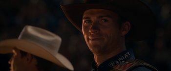 Movie still from “The Longest Ride” (2015), directed by George Tillman Jr. – A man wearing a cowboy hat looking into the distance; Close Up shot, Over the shoulder angle