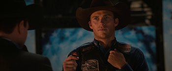 Movie still from “The Longest Ride” (2015), directed by George Tillman Jr. – A man wearing a cowboy hat and a vest; Close Up shot, Over the shoulder angle