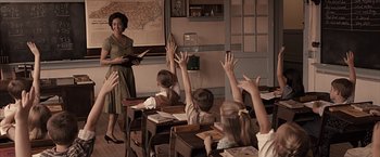 Movie still from “The Longest Ride” (2015), directed by George Tillman Jr. – A woman is teaching a class to a group of children; Medium shot, High angle
