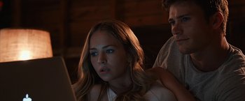 Movie still from “The Longest Ride” (2015), directed by George Tillman Jr. – A young woman sitting next to a man in a dark room; Close Up shot, Over the shoulder angle
