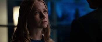 Movie still from “The Longest Ride” (2015), directed by George Tillman Jr. – A young woman looking into the distance in a dark room; Close Up shot, Over the shoulder angle