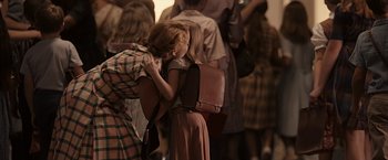 Movie still from “The Longest Ride” (2015), directed by George Tillman Jr. – A group of people that are standing in a room together; Medium shot, Over the shoulder angle