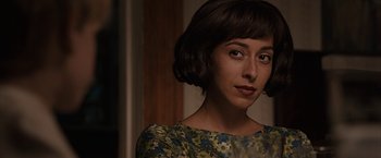 Movie still from “The Longest Ride” (2015), directed by George Tillman Jr. – A woman with short brown hair wearing a green and blue floral dress; Close Up shot, Over the shoulder angle