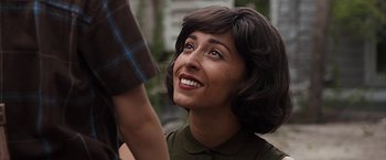 Movie still from “The Longest Ride” (2015), directed by George Tillman Jr. – A person smiling with a person holding her hand; Close Up shot, Over the shoulder angle