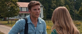 Movie still from “The Longest Ride” (2015), directed by George Tillman Jr. – A man and a woman talking in front of a white house; Close Up shot, Over the shoulder angle
