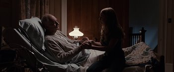 Movie still from “The Longest Ride” (2015), directed by George Tillman Jr. – An older man and a young girl in a hospital bed; Medium shot, High angle