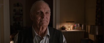 Movie still from “The Longest Ride” (2015), directed by George Tillman Jr. – An older man in a white shirt and a black vest; Close Up shot, Over the shoulder angle