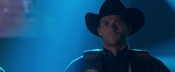 Movie still from “The Longest Ride” (2015), directed by George Tillman Jr. – A man wearing a cowboy hat in a dark room; Close Up shot, Low angle