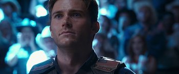 Movie still from “The Longest Ride” (2015), directed by George Tillman Jr. – A person with a flag on their chest; Close Up shot, Low angle