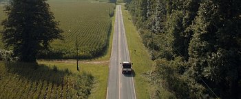 Movie still from “The Longest Ride” (2015), directed by George Tillman Jr. – An aerial view of a truck driving down a rural road; Extreme Wide shot, High angle