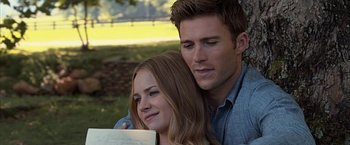Movie still from “The Longest Ride” (2015), directed by George Tillman Jr. – A man and a woman sitting next to each other in a park; Close Up shot, Low angle