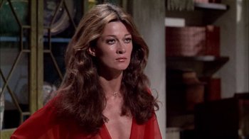 Movie still from “The Longest Yard” (1974), directed by Robert Aldrich – A woman in a red dress with long brown hair; Close Up shot, Low angle