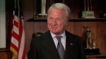 Movie still from “The Longest Yard” (1974), directed by Robert Aldrich – An older man wearing a suit and tie; Close Up shot, Low angle