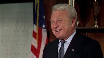 Movie still from “The Longest Yard” (1974), directed by Robert Aldrich – An older man wearing a suit and tie; Close Up shot, Low angle