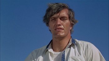 Movie still from “The Longest Yard” (1974), directed by Robert Aldrich – A person wearing a shirt and tie; Close Up shot, Low angle