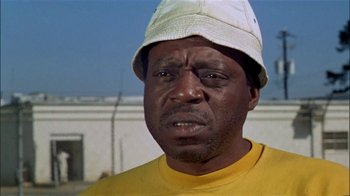 Movie still from “The Longest Yard” (1974), directed by Robert Aldrich – A person wearing a hat; Close Up shot, Low angle