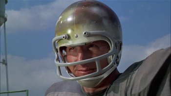 Movie still from “The Longest Yard” (1974), directed by Robert Aldrich – A person wearing a football helmet; Close Up shot, Low angle