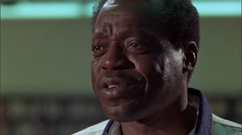 Movie still from “The Longest Yard” (1974), directed by Robert Aldrich – An older man is looking into the camera; Close Up shot, Low angle