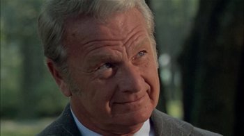 Movie still from “The Longest Yard” (1974), directed by Robert Aldrich – An older man in a suit and tie looking to his left; Close Up shot, Low angle