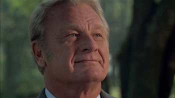 Movie still from “The Longest Yard” (1974), directed by Robert Aldrich – An older man in a suit and tie looking upward; Close Up shot, Low angle