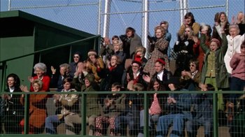 Movie still from “The Longest Yard” (1974), directed by Robert Aldrich – A group of people sitting on top of a baseball field; Wide shot, High angle