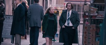 Movie still from “The Look of Love” (2013), directed by Michael Winterbottom – A woman and a man are walking down the street; Medium shot, Over the shoulder angle