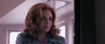 Movie still from “The Look of Love” (2013), directed by Michael Winterbottom – A person with long hair; Close Up shot, Over the shoulder angle