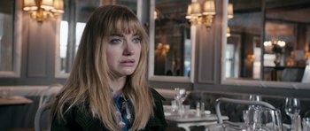 Movie still from “The Look of Love” (2013), directed by Michael Winterbottom – A person sitting at a table in a restaurant; Close Up shot, Over the shoulder angle