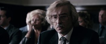 Movie still from “The Look of Love” (2013), directed by Michael Winterbottom – An older man wearing a suit and tie; Close Up shot, Over the shoulder angle