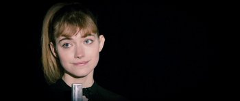 Movie still from “The Look of Love” (2013), directed by Michael Winterbottom – A person wearing a black shirt; Close Up shot, Over the shoulder angle