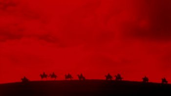 Movie still from “The Lord of the Rings” (1978), directed by Ralph Bakshi – A group of people riding on the back of a camel; Extreme Wide shot, Low angle