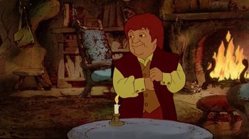 Movie still from “The Lord of the Rings” (1978), directed by Ralph Bakshi – A man standing in front of a table with a lit candle; Medium shot, Over the shoulder angle