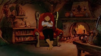 Movie still from “The Lord of the Rings” (1978), directed by Ralph Bakshi – A person sitting in a chair in front of a fire place; Wide shot, High angle